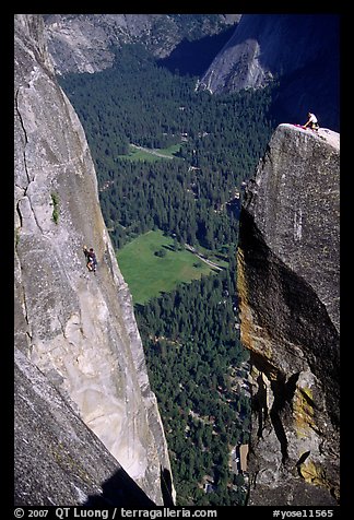 Climbers on Lost Arrow spire and Yosemite falls wall. Yosemite National Park, California