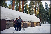 Skiing couple in front of the Mariposa Grove Museum in winter. Yosemite National Park, California ( color)