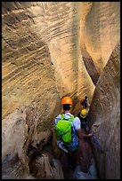 Canyoneers surrouned by tall walls in narrow section of Mystery Canyon. Zion National Park, Utah ( color)