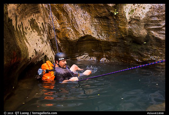 Canyoneer in pool of water, Mystery Canyon. Zion National Park, Utah (color)