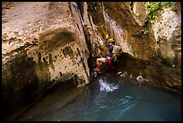 Canyoneer swings above water pool, Mystery Canyon. Zion National Park, Utah ( color)