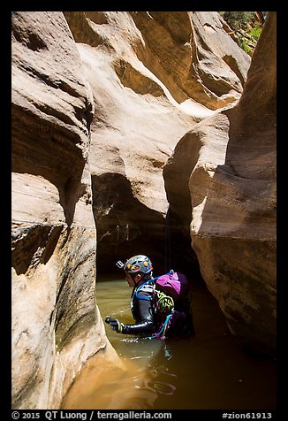 Canyoneer in sunny pool of water, Pine Creek Canyon. Zion National Park, Utah (color)
