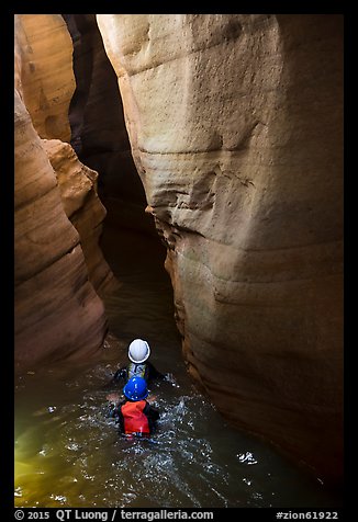 Canyoneers swim into narrow corridor, Pine Creek Canyon. Zion National Park, Utah (color)