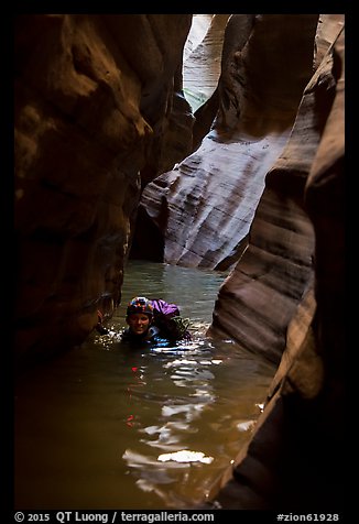 Woman in deep water of dark narrows, Pine Creek Canyon. Zion National Park, Utah (color)