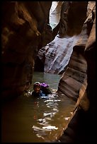 Woman in deep water of dark narrows, Pine Creek Canyon. Zion National Park, Utah ( color)