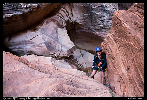 Woman rappels down in Pine Creek Canyon. Zion National Park, Utah (color)