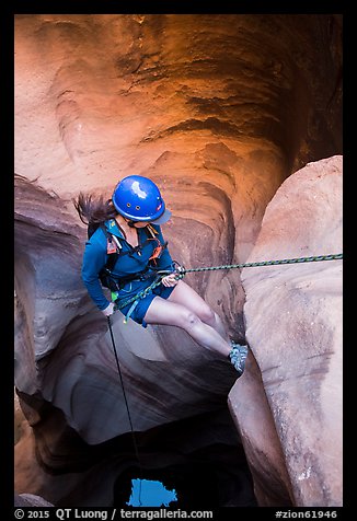 Woman setting out for free rappel in Pine Creek Canyon. Zion National Park, Utah (color)