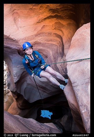 Woman at the start of free hanging rappel in Pine Creek Canyon. Zion National Park, Utah (color)
