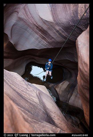 Woman on free hanging rappel in Pine Creek Canyon. Zion National Park, Utah (color)