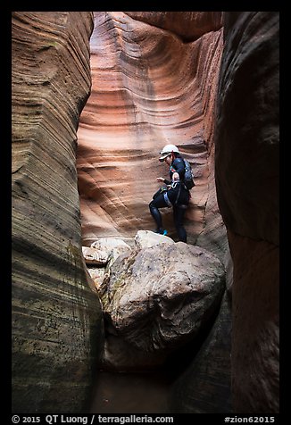 Canyoneer above chockstone, Keyhole Canyon. Zion National Park, Utah (color)