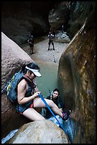 Canyoneer lowers herself using rope, Orderville Canyon. Zion National Park, Utah ( color)