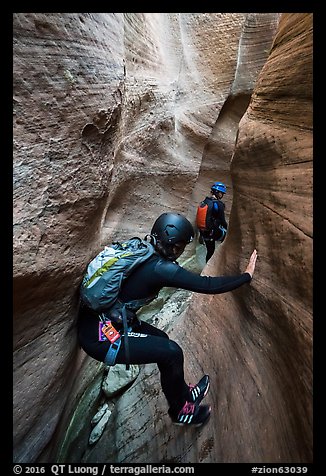 Canyoneer using chimney technique in narrow section of Keyhole Canyon. Zion National Park, Utah (color)