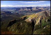 Aerial view of mountains with meandering Alatna river in the distance. Gates of the Arctic National Park, Alaska, USA.