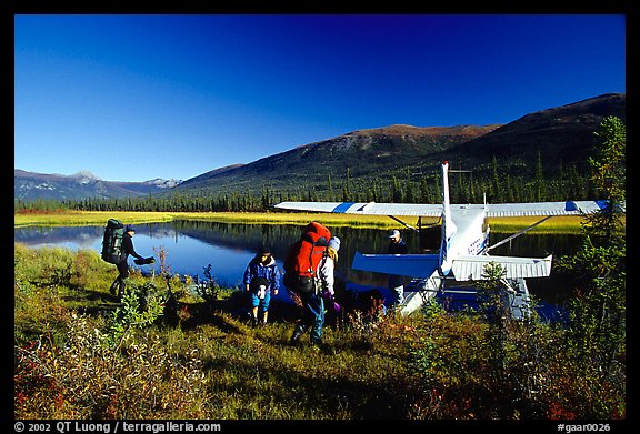 Backpackers beeing picked up by a floatplane at Circle Lake. Gates of the Arctic National Park, Alaska (color)