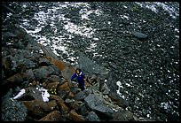 Backpacker in boulder field at the base of the Arrigetch Peaks. Gates of the Arctic National Park, Alaska (color)