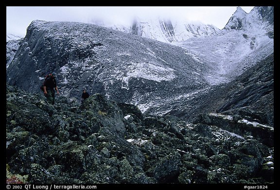 Backpackers on boulder fields in Aquarius Valley. Gates of the Arctic National Park, Alaska (color)