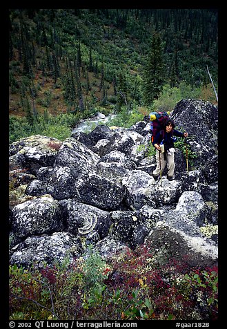 Backpacker on boulder field in Arrigetch Creek. Gates of the Arctic National Park, Alaska