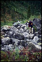 Backpacker on boulder field in Arrigetch Creek. Gates of the Arctic National Park, Alaska