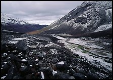 Boulders, valleys and slopes with fresh snow in cloudy weather. Gates of the Arctic National Park, Alaska, USA.