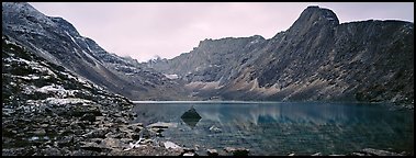 Mineral landscape with scree, rocky peaks, and lake. Gates of the Arctic National Park (Panoramic color)