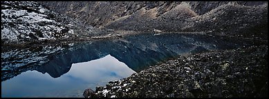 Mountain lake with reflections in rocky environment. Gates of the Arctic National Park (Panoramic color)