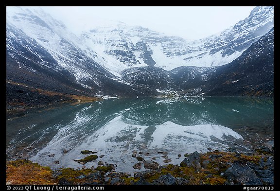Snowy Three River Mountain reflected in lake. Gates of the Arctic National Park, Alaska, USA.