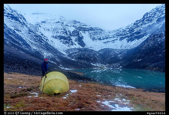 Camper standing by tent near  Lake and Three River Mountain. Gates of the Arctic National Park (color)