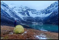 Camper standing by tent near  Lake and Three River Mountain. Gates of the Arctic National Park ( color)