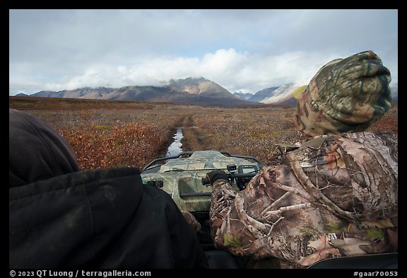 Nunamiut family on Argo following ATV trail. Gates of the Arctic National Park (color)