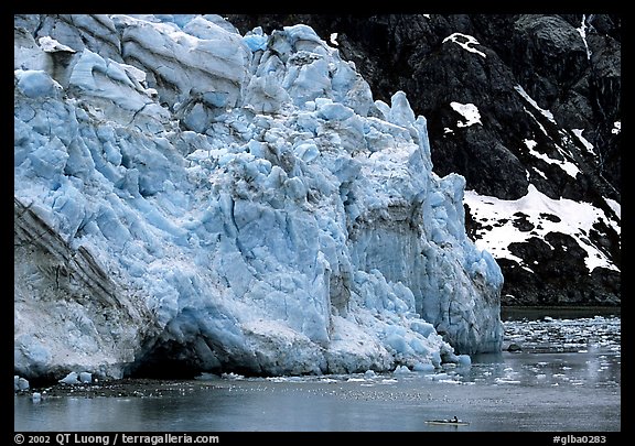 Kayaker dwarfed by Lamplugh glacier. Glacier Bay National Park (color)