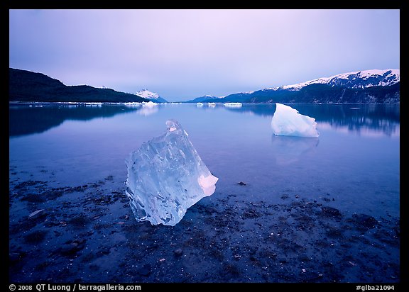 Beached translucent iceberg and Muir inlet at dawn. Glacier Bay National Park (color)