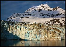 Face of Lamplugh Glacier illuminated by the sun on cloudy day. Glacier Bay National Park, Alaska, USA.