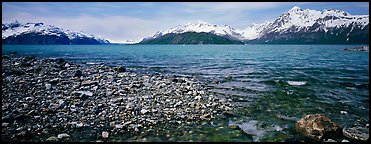 Snowy mountains rising above water. Glacier Bay National Park, Alaska, USA.