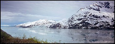 Snowy mountains rising above fjord. Glacier Bay National Park, Alaska, USA.