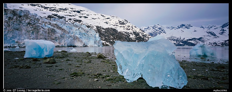 Beach iceberg and tidewater glacier front. Glacier Bay National Park, Alaska, USA.