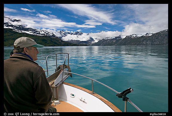 Man sitting at the bow of a small boat. Glacier Bay National Park, Alaska, USA.