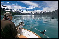 Man sitting at the bow of a small boat. Glacier Bay National Park, Alaska, USA. (color)