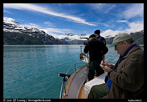 Film producer taking notes as crew films. Glacier Bay National Park, Alaska, USA.