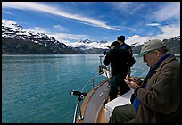 Film producer taking notes as crew films. Glacier Bay National Park, Alaska, USA.