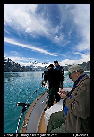 Movie producer taking notes as crew films. Glacier Bay National Park, Alaska, USA.