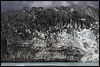 Ice colored by black moraining debris on the front of Margerie Glacier. Glacier Bay National Park, Alaska, USA.