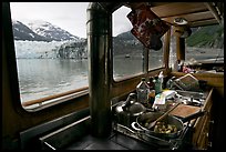 Breakfast potatoes in a small boat moored in front of glacier. Glacier Bay National Park, Alaska, USA.