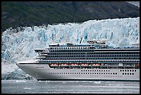 Cruise ship dwarfed by the face of Margerie Glacier. Glacier Bay National Park, Alaska, USA.