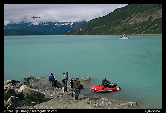 Film crew met by a skiff after shore excursion. Glacier Bay National Park, Alaska, USA.