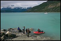 Film crew met by a skiff after shore excursion. Glacier Bay National Park, Alaska, USA.