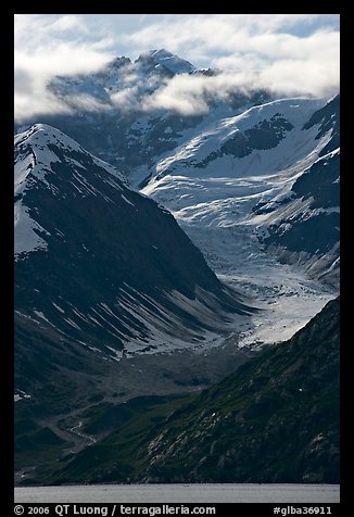 Topeka Glacier, peak and clouds, late afternoon. Glacier Bay National Park, Alaska, USA.