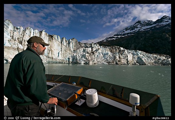 Captain guiding boat near Lamplugh glacier. Glacier Bay National Park, Alaska, USA.