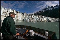 Captain guiding boat near Lamplugh glacier. Glacier Bay National Park ( color)