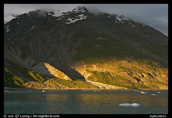 Sunset light falling on the base of the peaks around Tarr Inlet. Glacier Bay National Park, Alaska, USA.