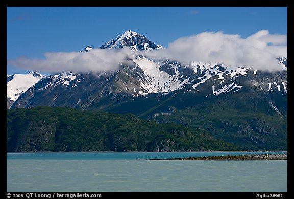 Snowy peaks and clouds raising above turquoise waters in sunny weather. Glacier Bay National Park (color)